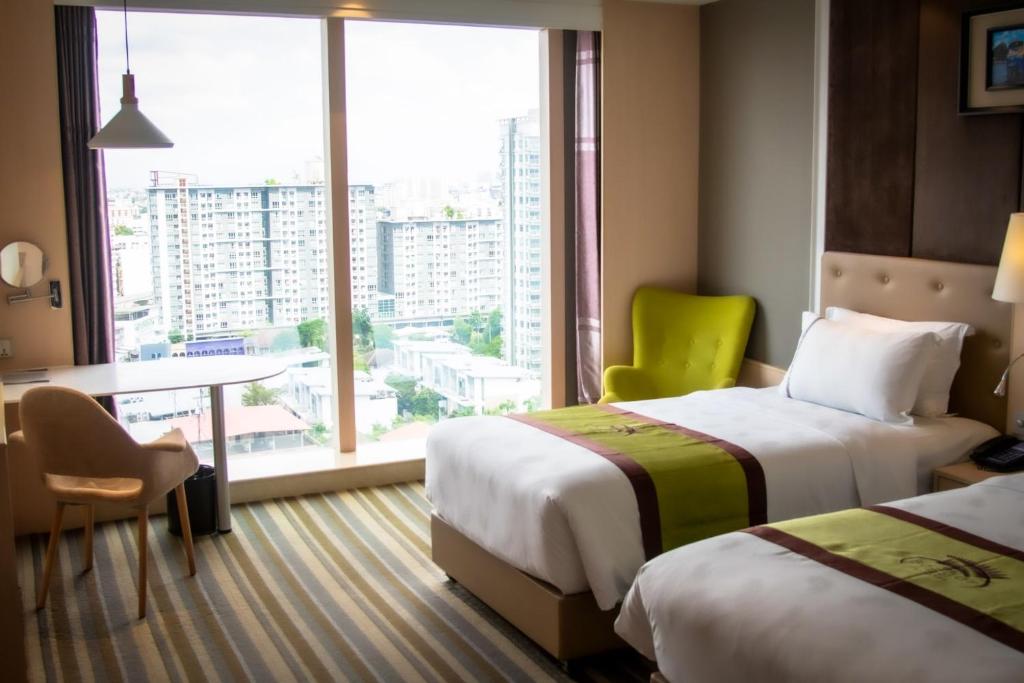 Postel nebo postele na pokoji v ubytování The Bazaar Hotel Bangkok