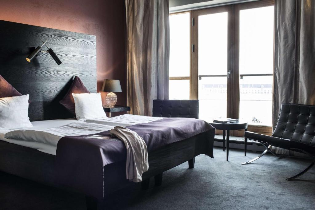 a bedroom with a bed and a large window at Scandic Front in Copenhagen