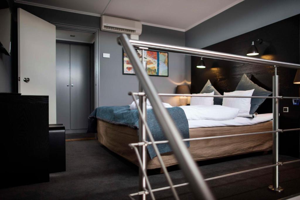 a bedroom with a bed with white sheets and pillows at Scandic Front in Copenhagen