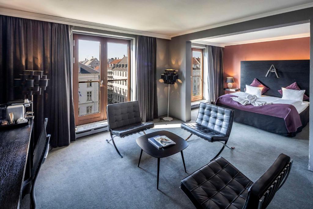 a hotel room with a bedroom with a bed and a window at Scandic Front in Copenhagen