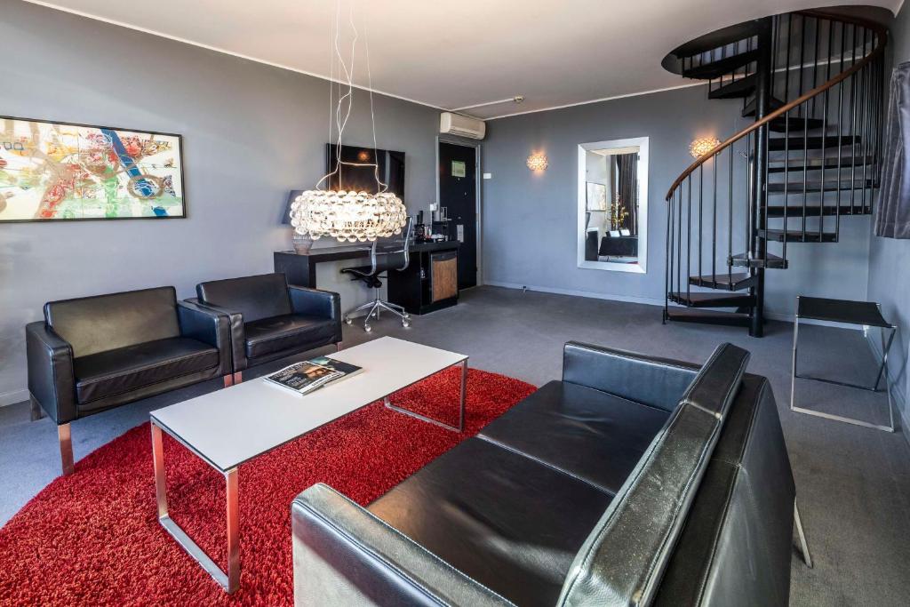 a living room with a couch and a table at Scandic Front in Copenhagen