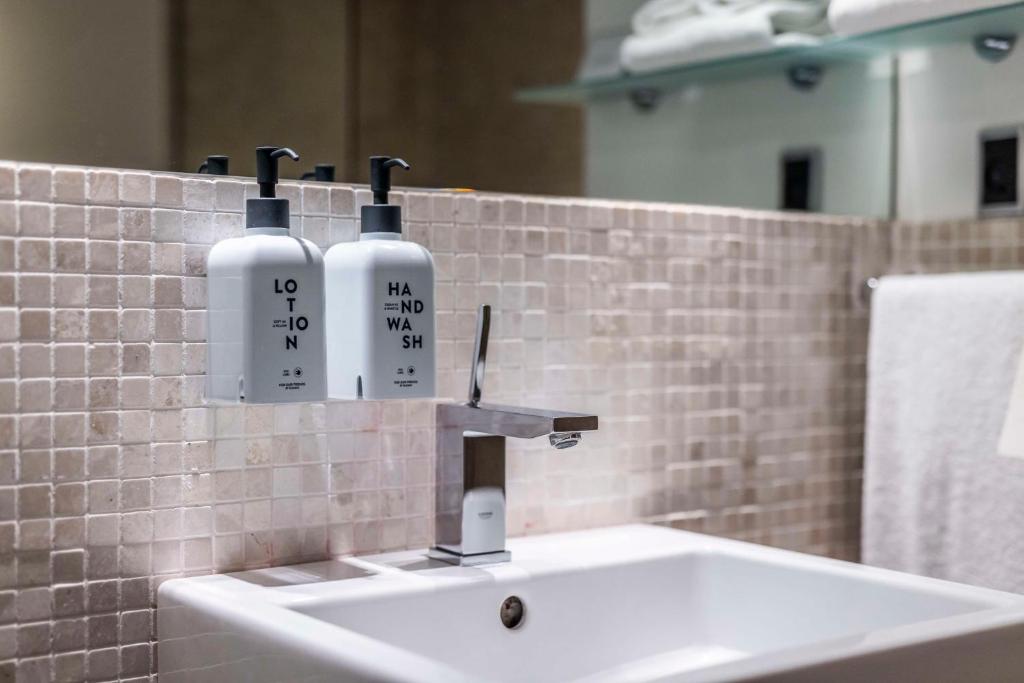 two bottles on a sink in a bathroom at Scandic Front in Copenhagen
