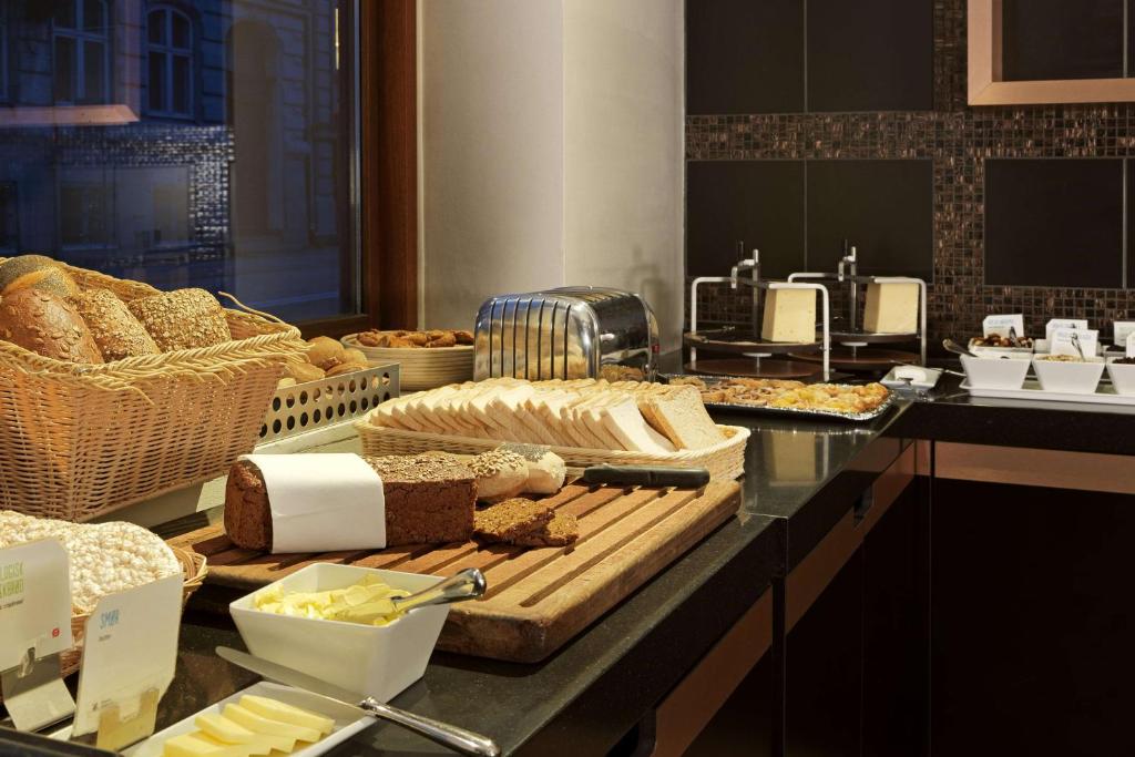 a buffet with bread and other food on a counter at Scandic Front in Copenhagen