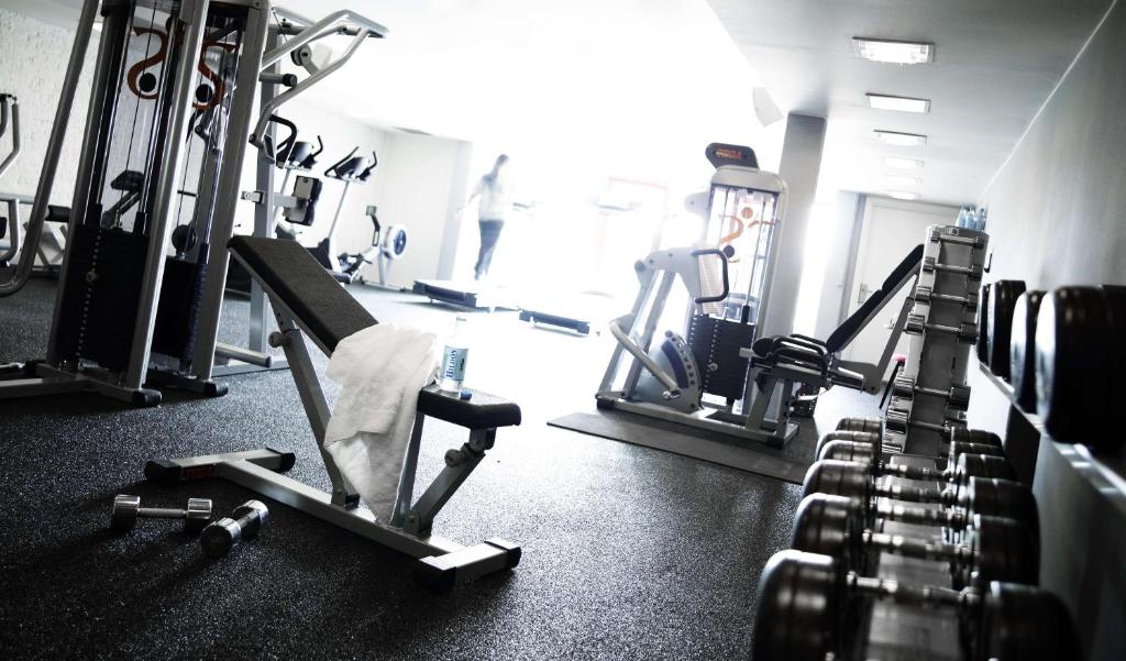 a gym with several treadmills and machines at Scandic Front in Copenhagen