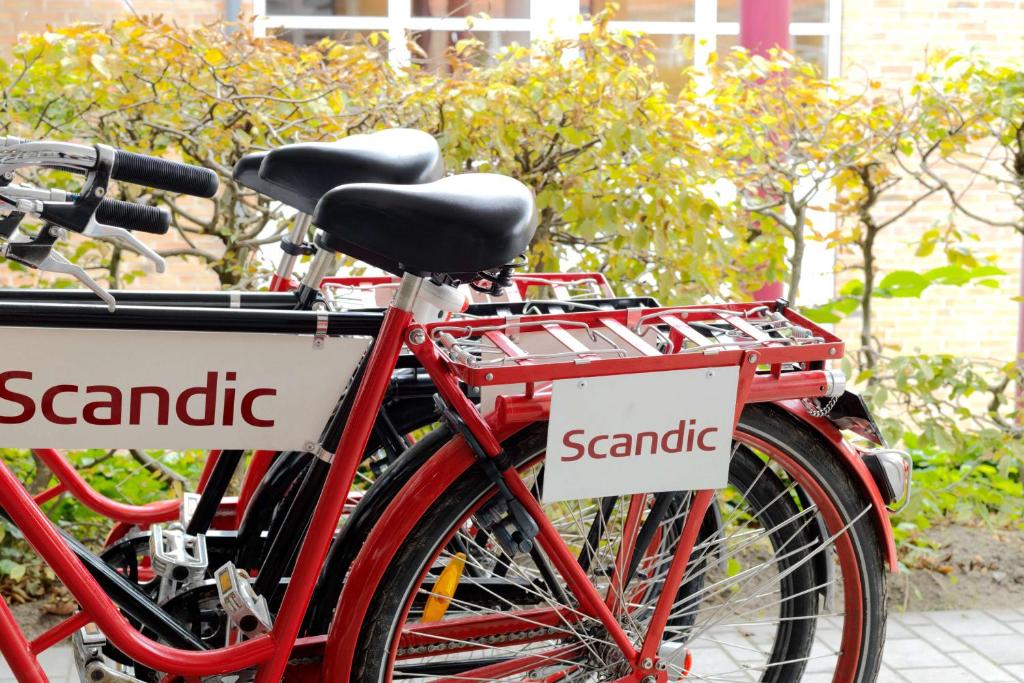 two red bikes parked next to each other with signs on them at Scandic Front in Copenhagen