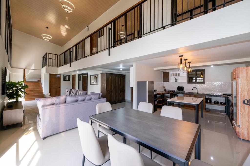 a dining room and living room with a table and chairs at The Warehouse Loft in Baguio