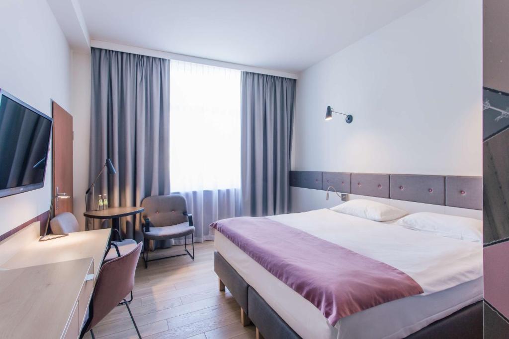 Postel nebo postele na pokoji v ubytování Scandic Gdańsk