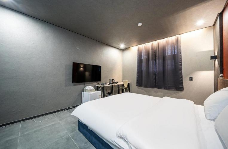 Postel nebo postele na pokoji v ubytování Moonstay Hotel Cheonan
