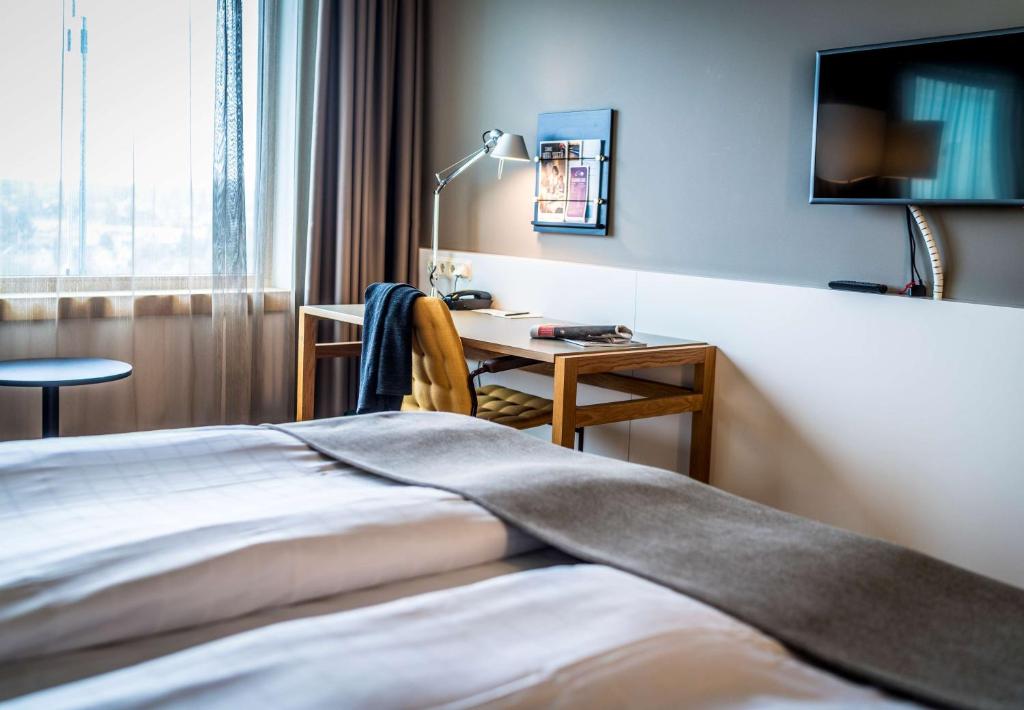 Postel nebo postele na pokoji v ubytování Scandic Talk