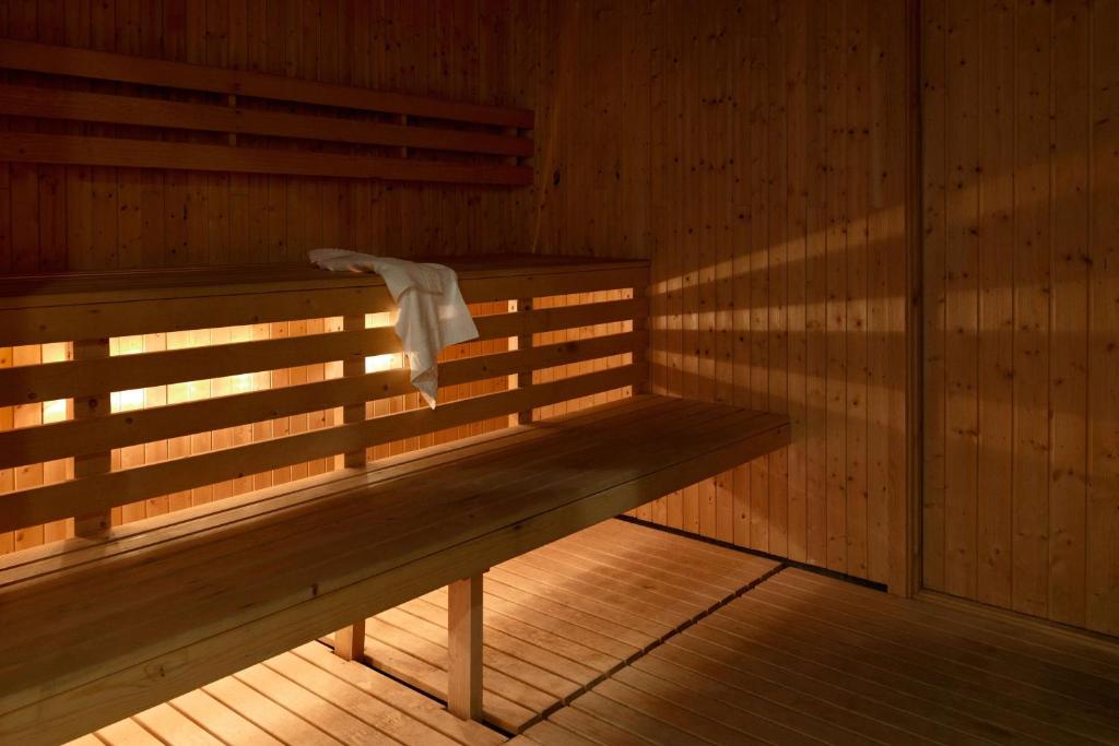 a sauna with a towel sitting on a bench at Scandic Stavanger Airport in Sola