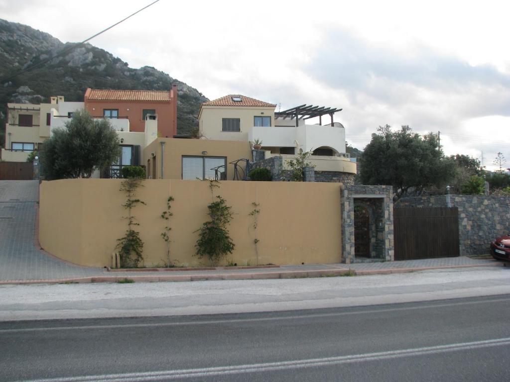 a yellow wall with plants on the side of a street at Paradise Villa in Istro