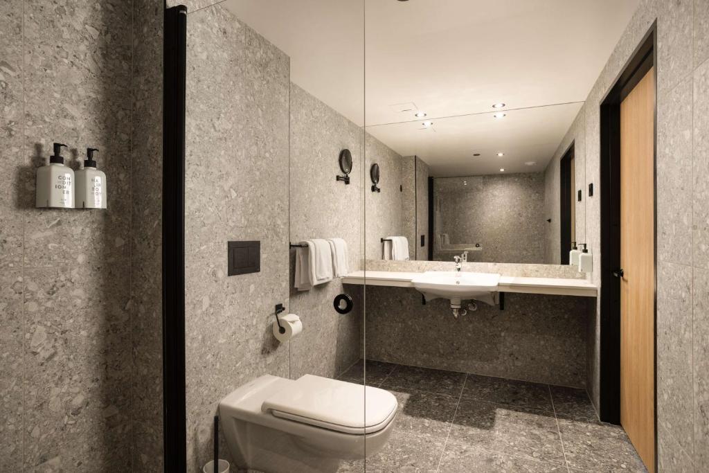 a bathroom with a toilet and a sink at Scandic Victoria in Oslo