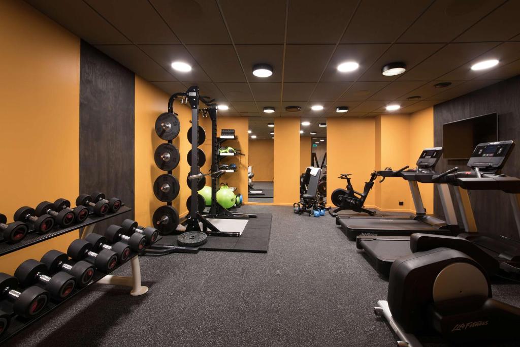 a gym with a bunch of machines and weights at Scandic Victoria in Oslo