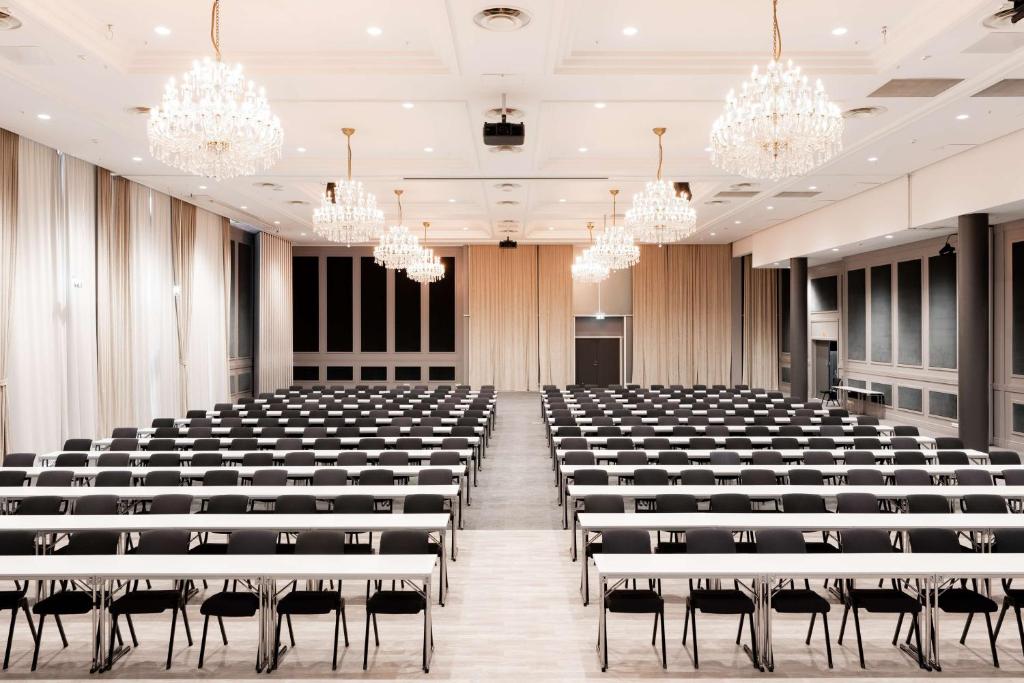 an empty conference room with chairs and chandeliers at Scandic Hell in Hell