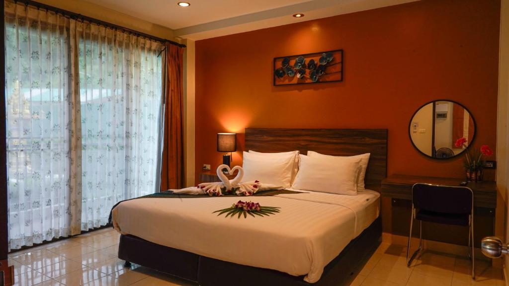 a bedroom with a bed with a swan on it at Katanoi Resort in Kata Beach