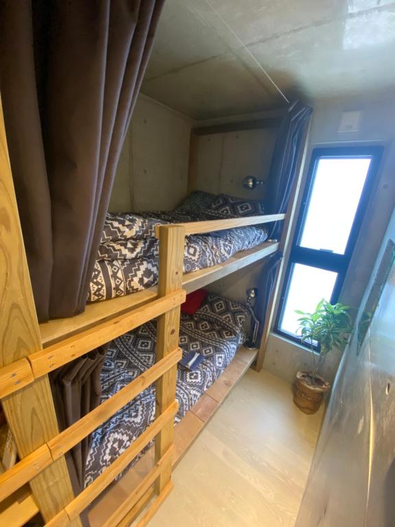 Postel nebo postele na pokoji v ubytování Sesoko Blue
