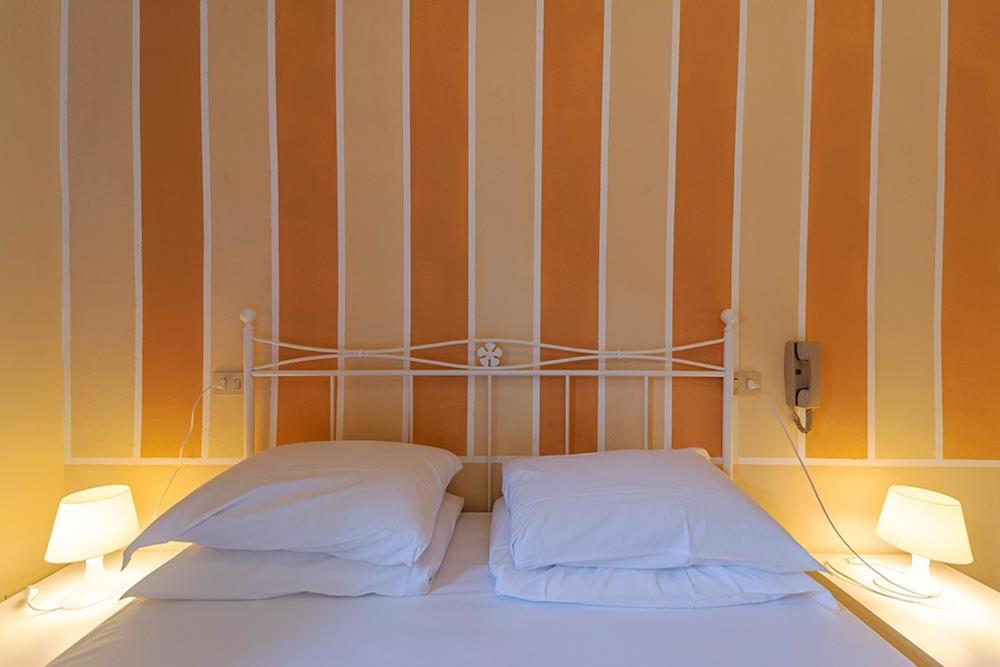 Postel nebo postele na pokoji v ubytování Hotel Casa Lupi