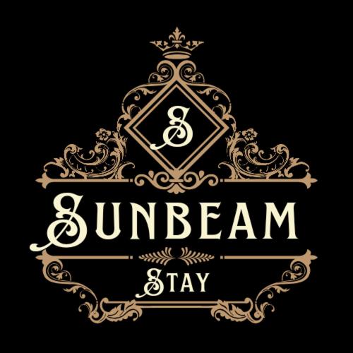 a gold logo with a sign that says sunbeam stay at Sunbeam Stay in Prayagraj