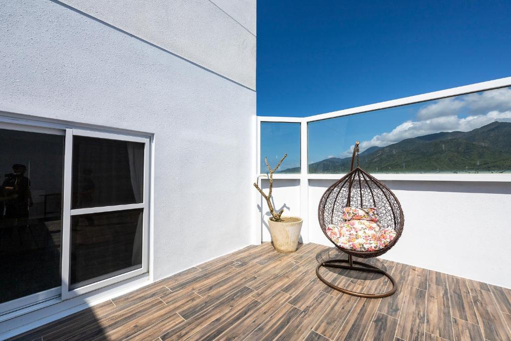 a porch with a bird cage sitting on a deck at Kenting Long Beach Hotel in Checheng