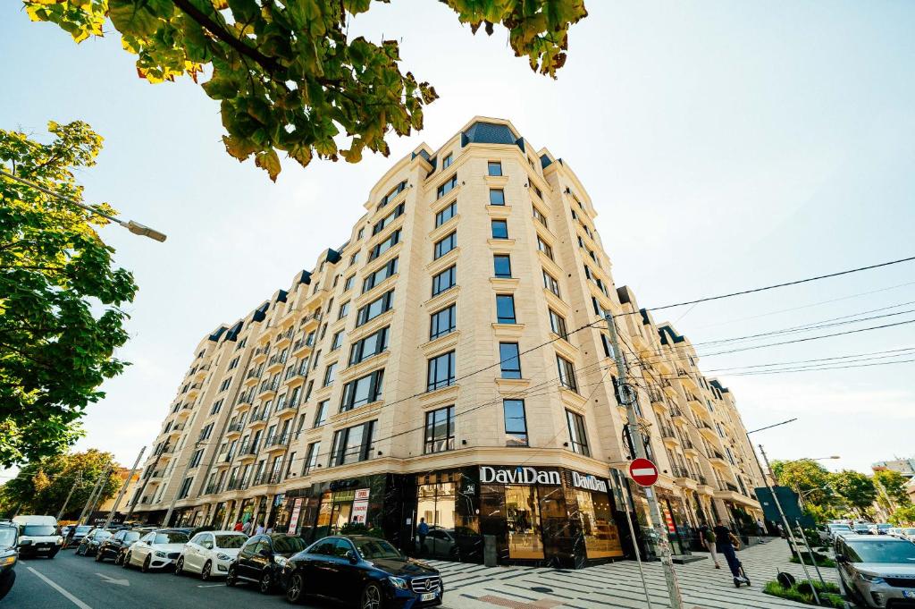 a large building on a city street with cars parked at Eminescu Residence! in Chişinău