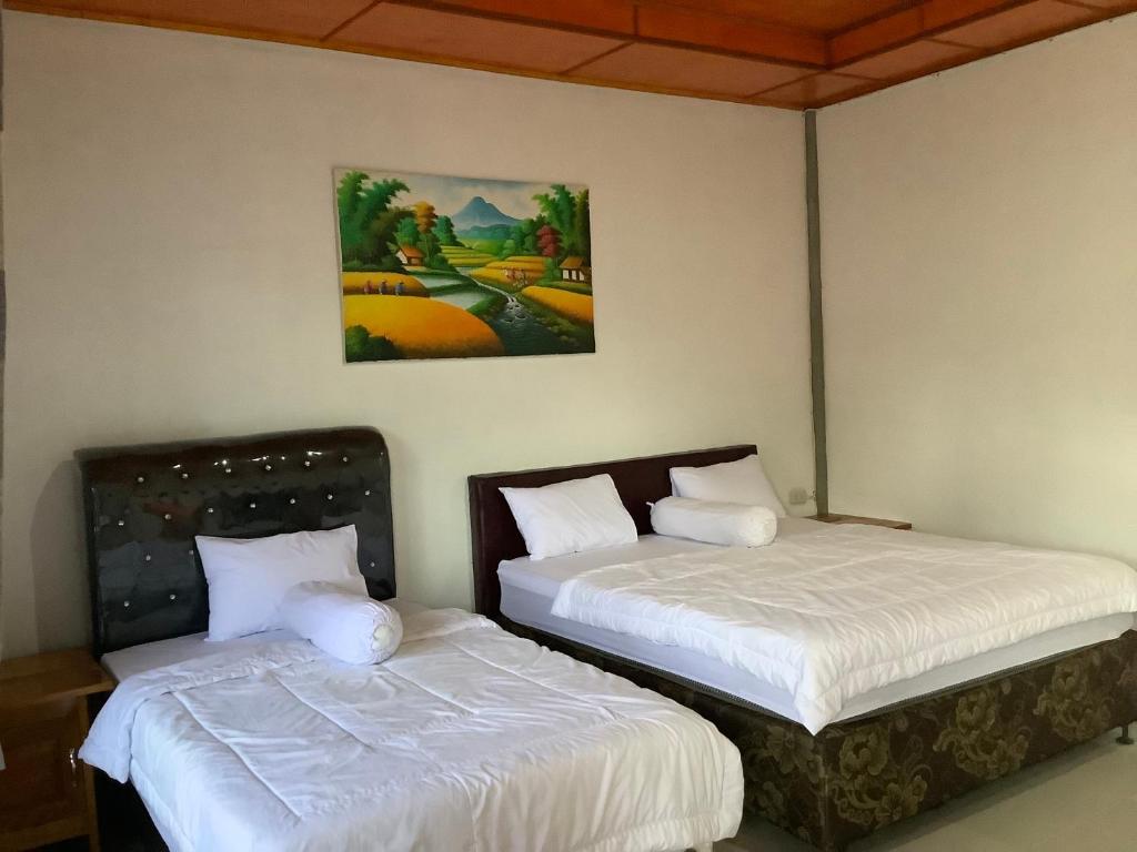 Postel nebo postele na pokoji v ubytování Matraville Home Stay Tuk Tuk Lake Toba Samosir