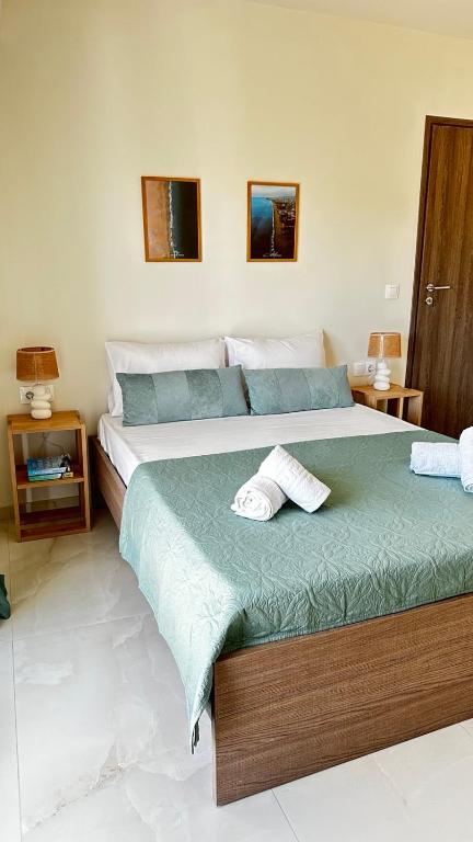 a bedroom with two beds with towels on them at Golden sand apartment A in Hersonissos