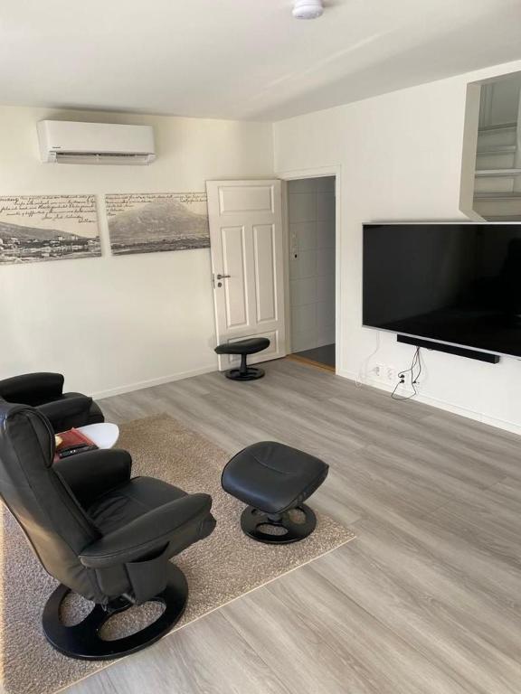 a living room with a chair and a television at seafront villa in Dragland
