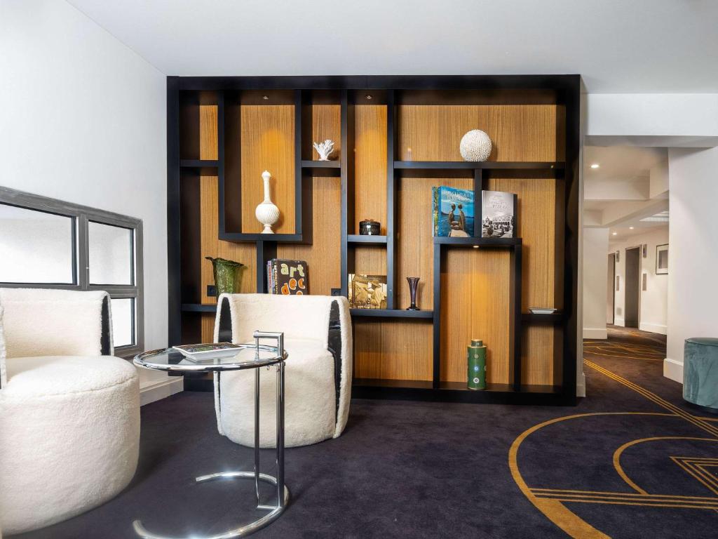 a living room with a couch and a table at The 1932 Hotel & Spa Cap d'Antibes - MGallery Collection in Juan-les-Pins