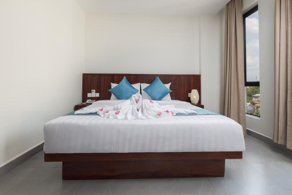 Postel nebo postele na pokoji v ubytování Angkor Channary Hotel