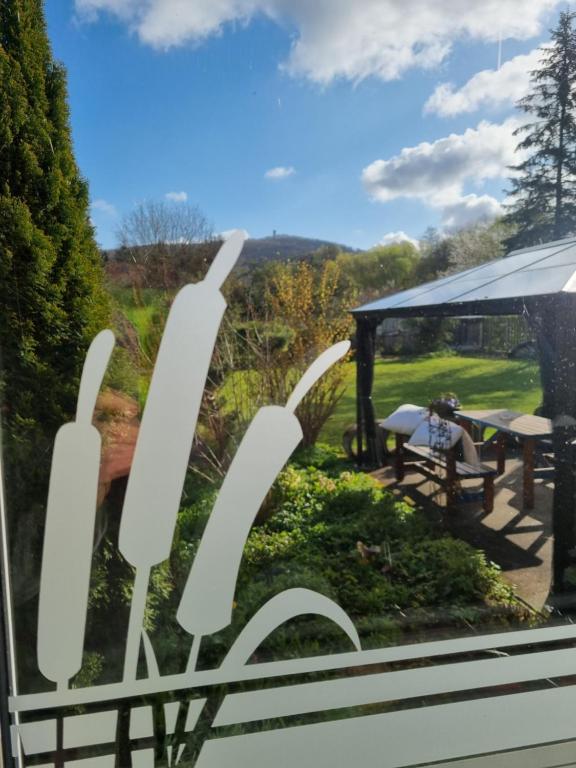 a view of a garden from a window at Ferienhaus ILMHOF in Bad Berka