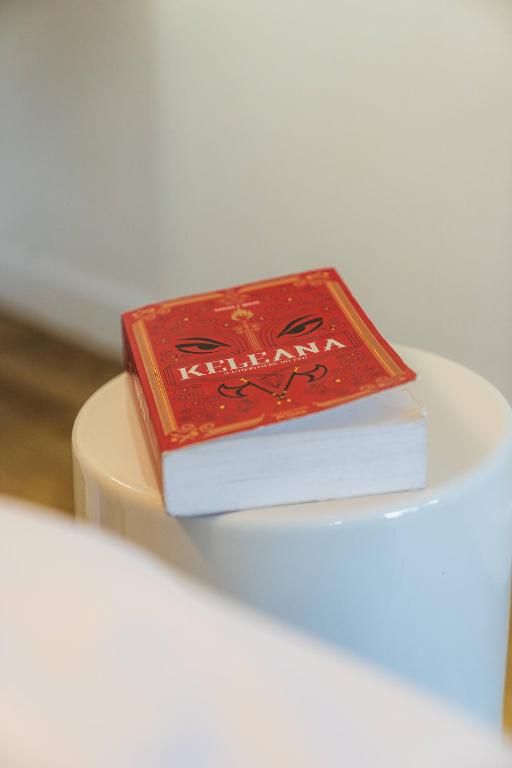 two books sitting on top of a white plate at Kyriad Cannes - Mandelieu in Cannes