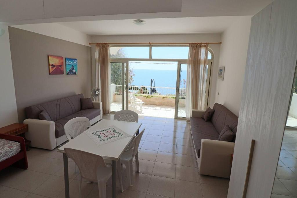 a living room with a couch and a table at Casa Nisea Modern Two-Level Home with Sea View in Santa Cesarea Terme in Santa Cesarea Terme