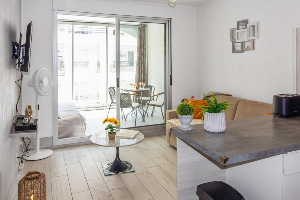 Il comprend une cuisine et un salon avec une table. dans l'établissement Le Bricka - Hypercentre - Cosy - 2 min from the sea, à Antibes