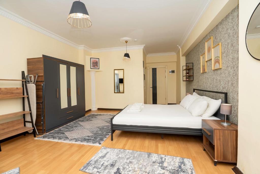 a bedroom with a bed and a dresser in it at Black Stone Homes in Aksu