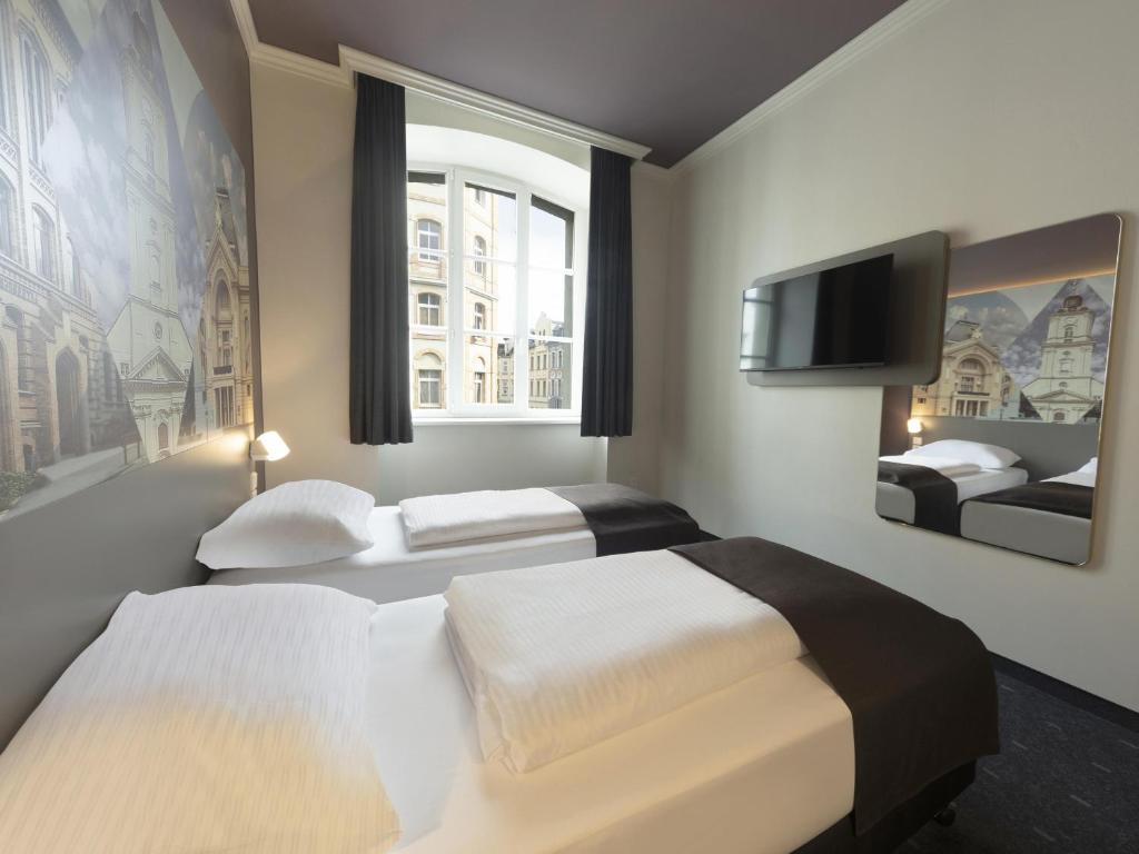 Postel nebo postele na pokoji v ubytování B&B HOTEL Gera