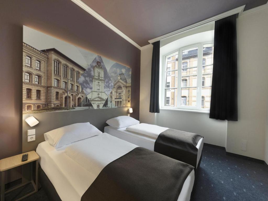 Postel nebo postele na pokoji v ubytování B&B HOTEL Gera