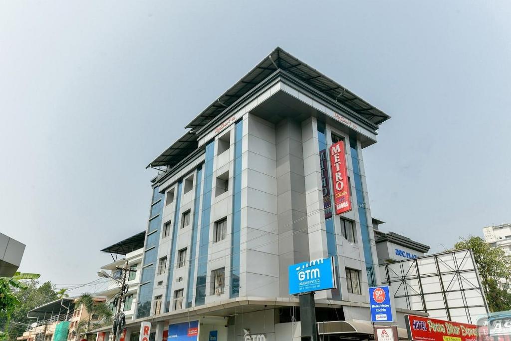 a tall white building with a pointed roof at Metro Kochin Business Hotel in Ernakulam