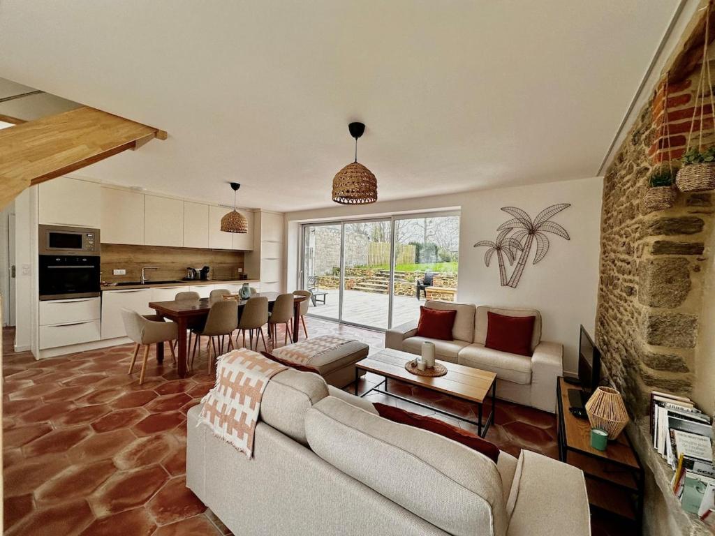 a living room with a couch and a table at Maison cosy proche Cancale et Mont-Saint-Michel in Saint-Méloir-des-Ondes