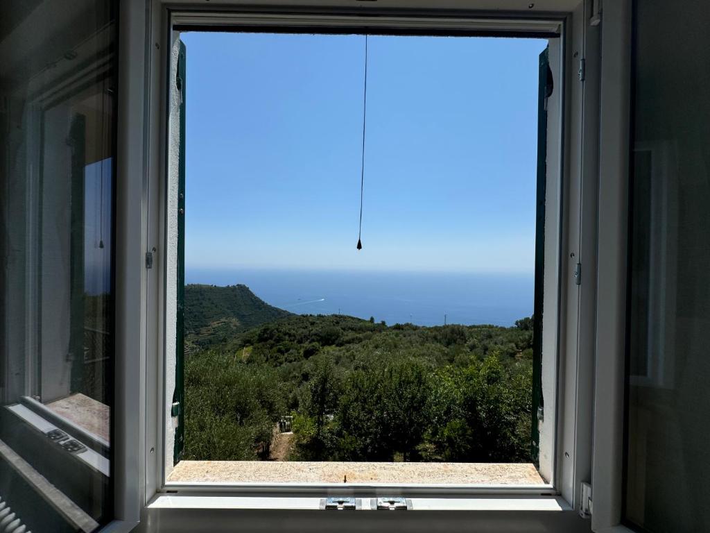 a window with a view of a mountain view at Ca' dii Bürsa 2 - HOMY 5 TERRE in Volastra