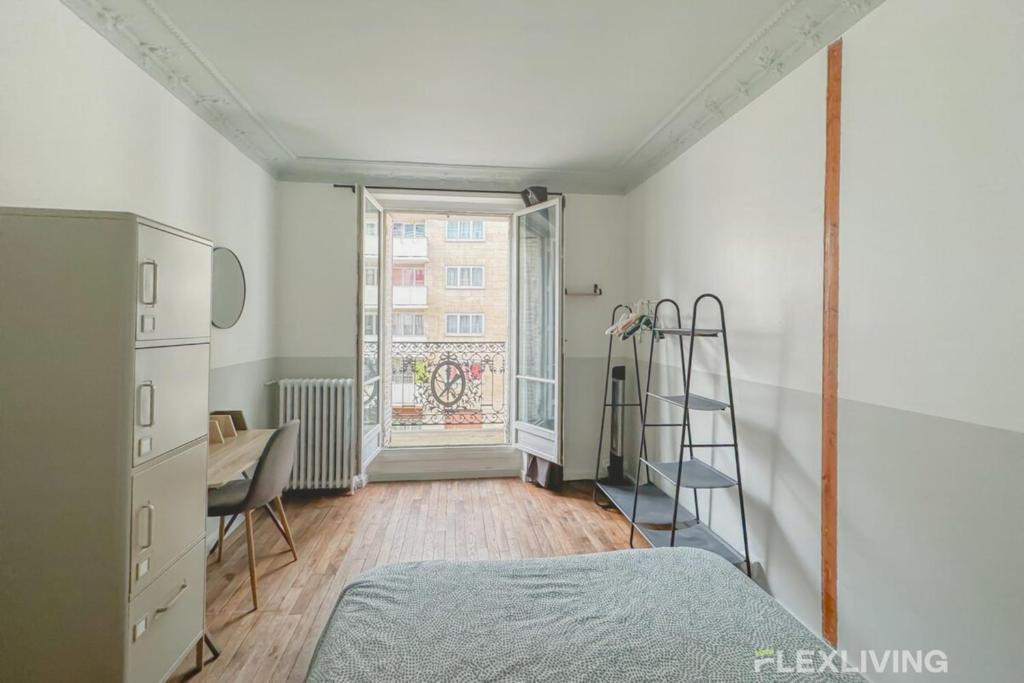 a bedroom with a bed and a ladder and a window at Flexliving - room - Paris 15 in Paris