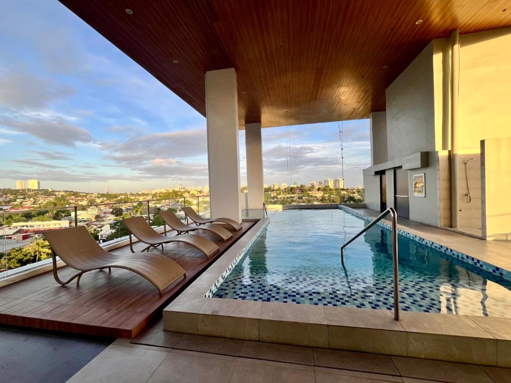 a swimming pool on the roof of a building at Aizen's haven at Casa Mira Guadalupe in Cebu City