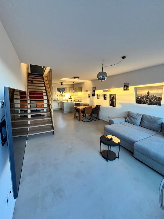 a living room with a couch and a staircase at Heimerzheim-Hills in Swisttal