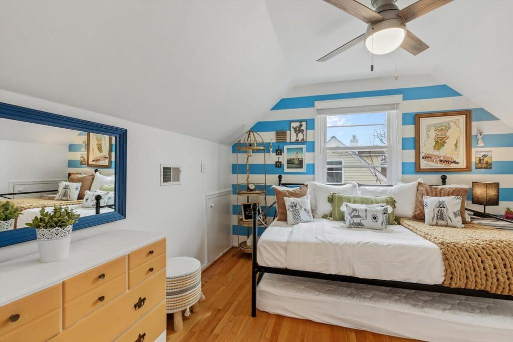 a bedroom with a bed with blue and white stripes at ALX Cape Cod 3-BR Near Old Town & Mount Vernon in Alexandria
