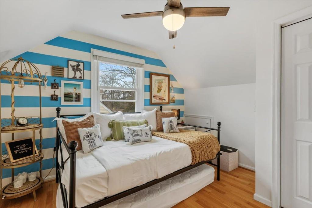 a bedroom with a bed with blue and white stripes at ALX Cape Cod 3-BR Near Old Town & Mount Vernon in Alexandria
