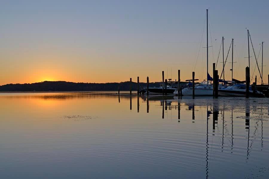 a dock with boats in the water at sunset at ALX Cape Cod 3-BR Near Old Town & Mount Vernon in Alexandria