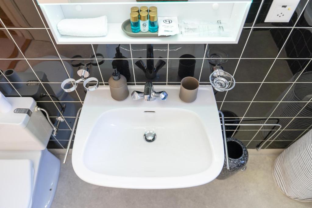 a bathroom with a white sink in a room at Gemütliche Wohnung Nähe Uni in Basel