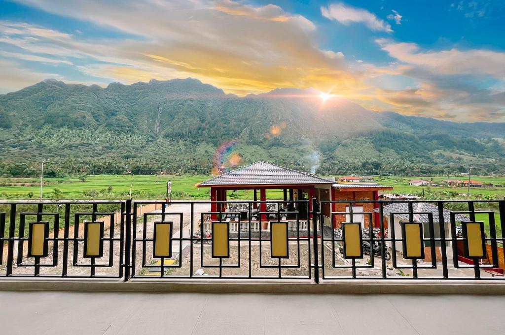 a gate with a view of a mountain at Simangande View & Resto by Staigo in Ambarita
