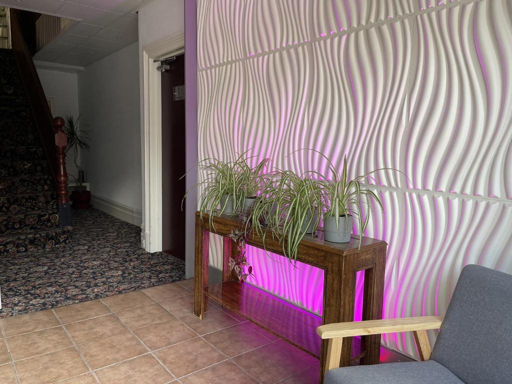 a room with a table with potted plants on it at The Bawdens Holiday Apartments in Blackpool