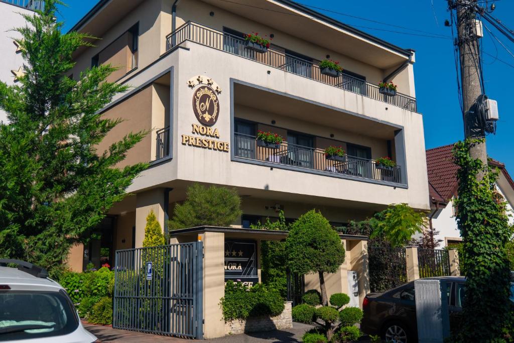 a hotel building with potted plants on the balconies at Nora Prestige in Timişoara