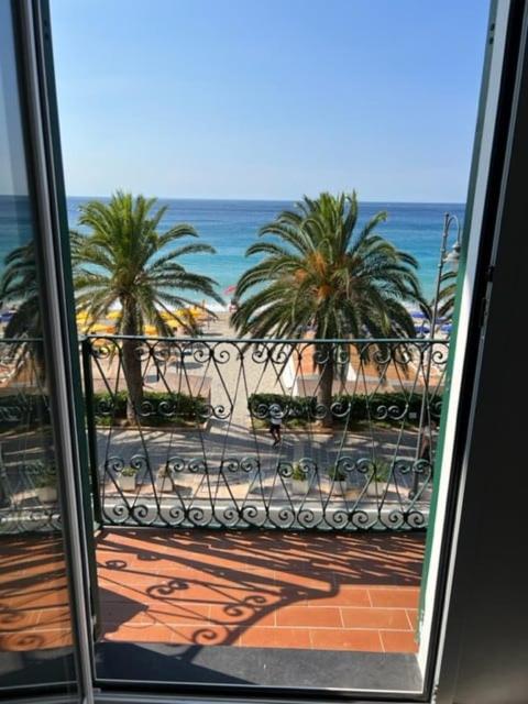 a view of a balcony with palm trees and the ocean at House on the beach Varigotti in Varigotti